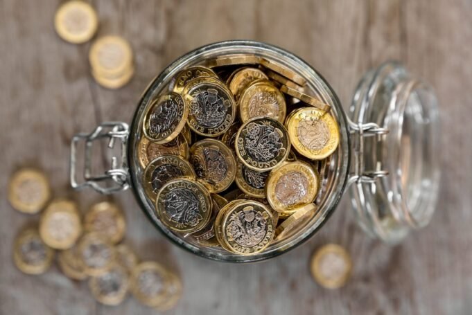 A jar full of saved one pound coins.