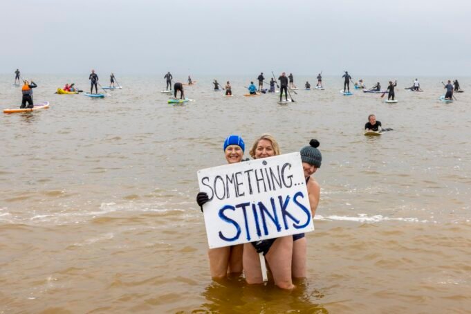 Surfers Against Sewage were joined by local surfers, paddle boarders, dippers and sea swimmers for a Paddle Out on Hythe beach to protest about the continued dumping of sewage into the UK's seas and beaches on the 18th May 2024, in Hythe, United Kingdom. Surfers Against Sewage organised a day of national protest across the country campaigning for water companies again to stop dumping sewage in our seas and rivers. (photo by Andrew Aitchison / In pictures via Getty Images)